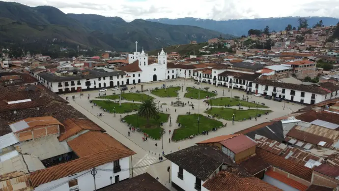 an aerial view of a city with a church in the center